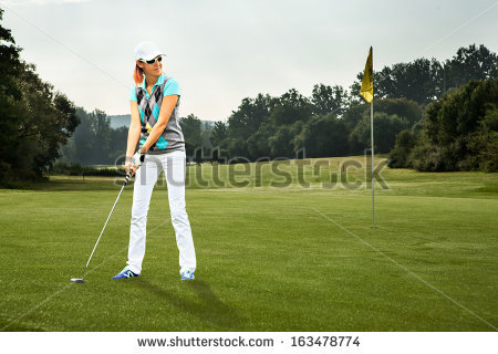 stock-photo-female-golf-player-with-a-golf-club-on-the-course-163478774