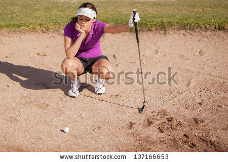 stock-photo-young-female-golfer-frustrated-and-stuck-in-a-sand-trap-137166653