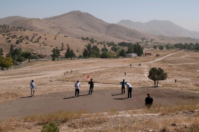 Golfers enjoy the outdoors and the opportunity to escape the city at the Kabul Golf Club, Kabul, Afghanistan.  The nine hole (18 holes if played in reverse) par 36 course is 5,522 yards of hard packed desert sand, scrub brush, ants, and persistent thorns.  The course has no grass. The greens are Òbrowns,Ó made from sand saturated with motor oil to keep them from blowing away.