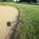 Should you leave the rake in or out of a bunker on the golf course?