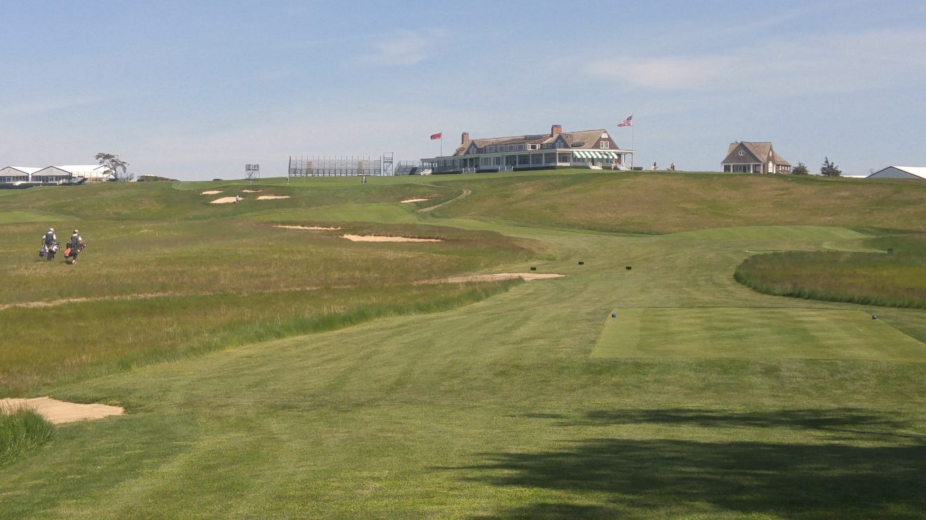 A view of the Shinnecock Hills clubhouse from the ninth tee, obscuring the fairway.