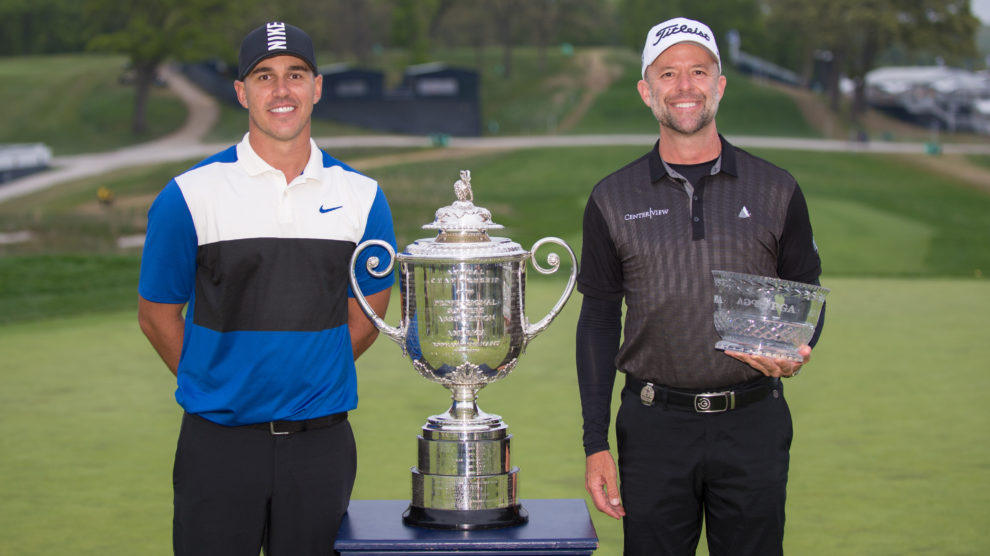 A photo of two golfers and the Wanamaker Trophy